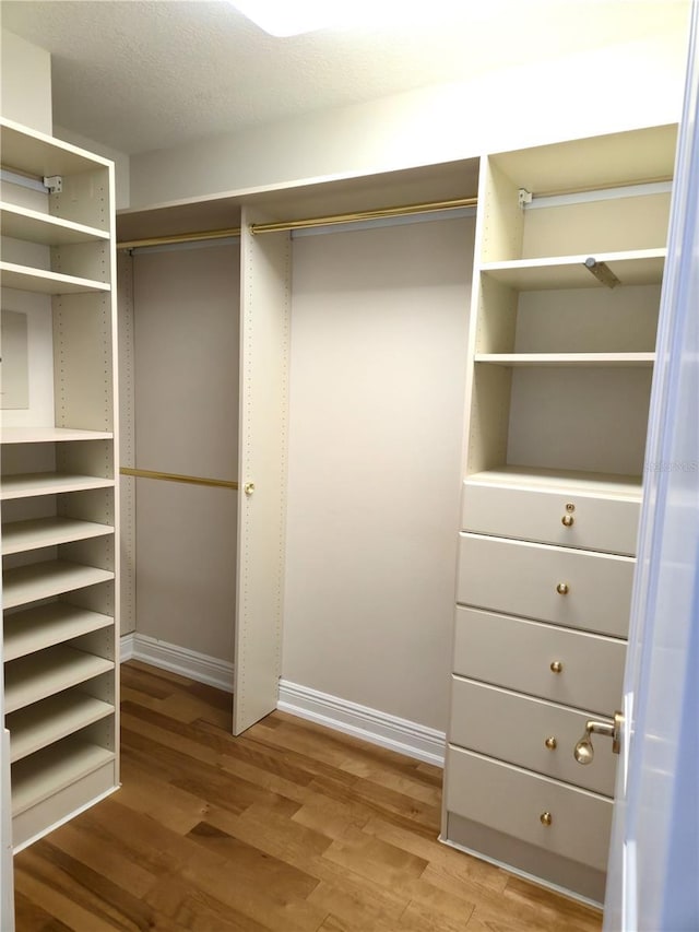 35 Watergate Dr Unit 1103, Sarasota, FL 34236 - walk in closet featuring wood finished floors