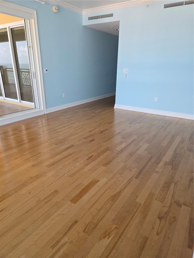 35 Watergate Dr Unit 1103, Sarasota, FL 34236 - spare room with crown molding, light wood-type flooring, and a smoke detector