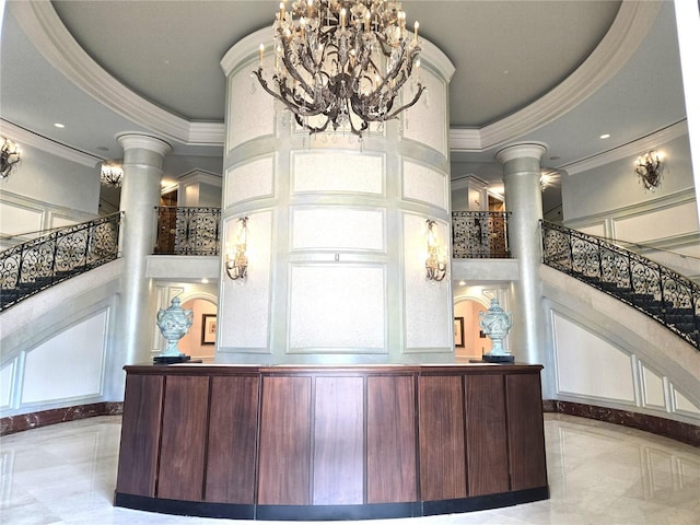 35 Watergate Dr Unit 1103, Sarasota, FL 34236 - welcome area featuring ornate columns, crown molding, a towering ceiling, stairway, and recessed lighting