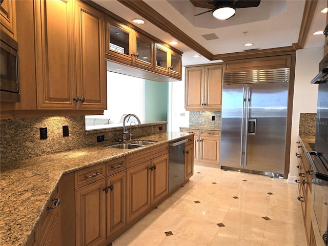 35 Watergate Dr Unit 1103, Sarasota, FL 34236 - kitchen with built in appliances, ceiling fan, a raised ceiling, backsplash, and stone countertops
