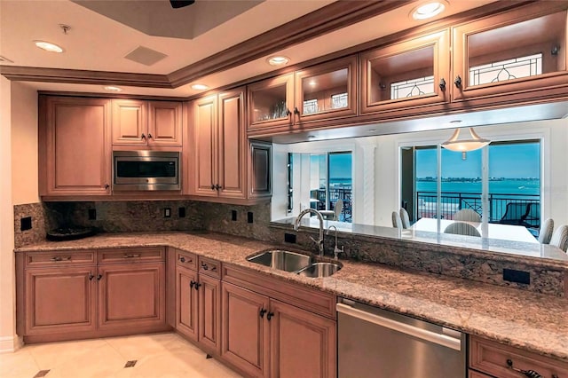 35 Watergate Dr Unit 1103, Sarasota, FL 34236 - kitchen featuring stainless steel appliances, decorative backsplash, light stone countertops, glass insert cabinets, and recessed lighting