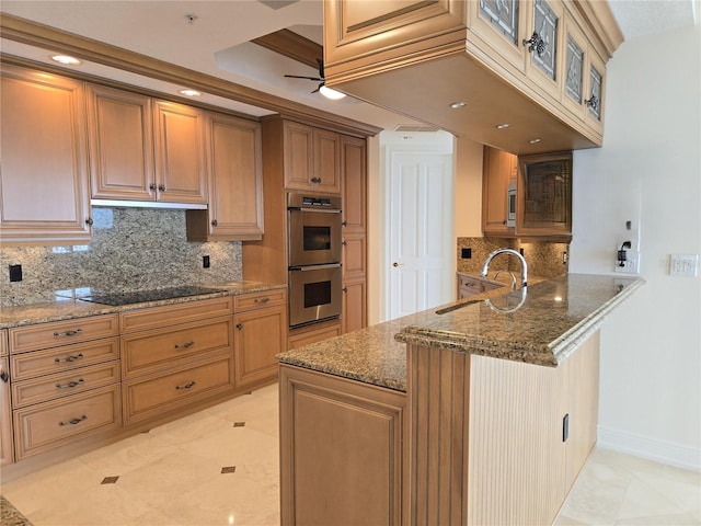 35 Watergate Dr Unit 1103, Sarasota, FL 34236 - kitchen featuring double oven, a peninsula, dark stone counters, backsplash, and black electric stovetop