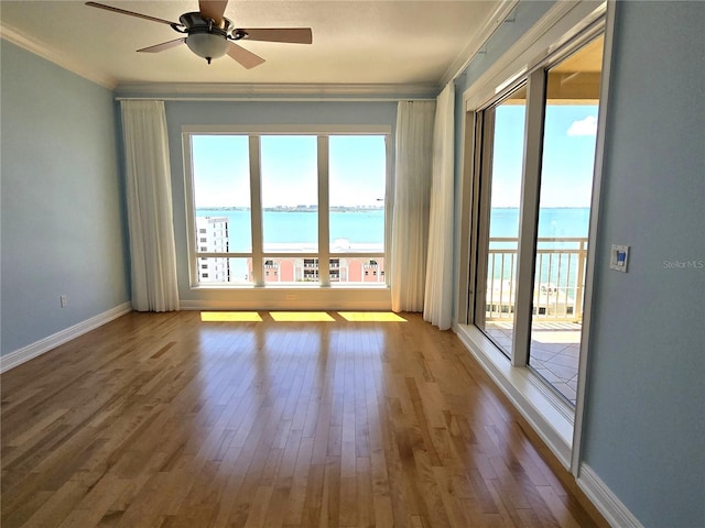 35 Watergate Dr Unit 1103, Sarasota, FL 34236 - unfurnished room with crown molding, a water view, wood finished floors, and a ceiling fan