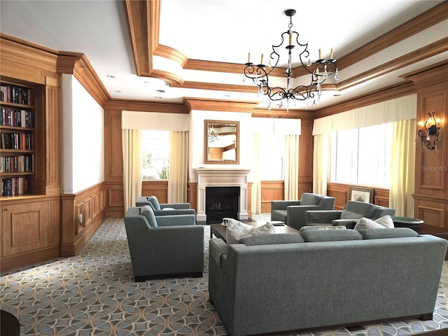 35 Watergate Dr Unit 1103, Sarasota, FL 34236 - living room featuring crown molding, a decorative wall, a chandelier, a fireplace, and dark colored carpet