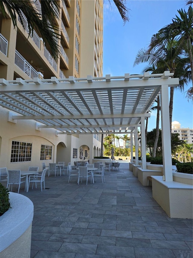 35 Watergate Dr Unit 1103, Sarasota, FL 34236 - view of patio with outdoor dining space and a pergola