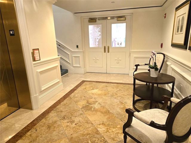 35 Watergate Dr Unit 1103, Sarasota, FL 34236 - foyer with a decorative wall, wainscoting, inlaid floor details, stairway, and stone tile flooring