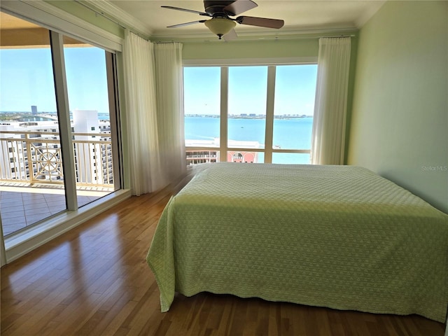 35 Watergate Dr Unit 1103, Sarasota, FL 34236 - bedroom with ornamental molding, access to exterior, a water view, wood finished floors, and ceiling fan