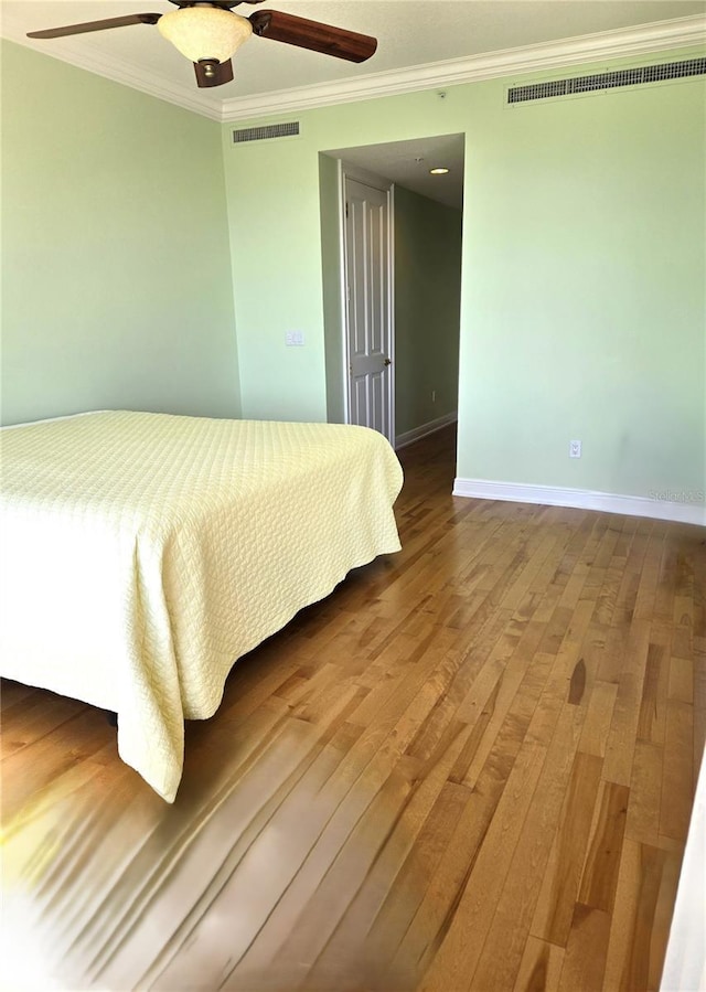 35 Watergate Dr Unit 1103, Sarasota, FL 34236 - bedroom featuring crown molding, hardwood / wood-style floors, and a ceiling fan