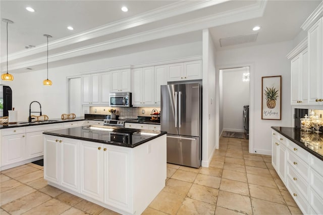 kitchen featuring appliances with stainless steel finishes, white cabinets, a sink, and tasteful backsplash