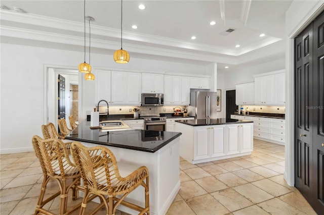 kitchen with visible vents, appliances with stainless steel finishes, ornamental molding, a sink, and backsplash