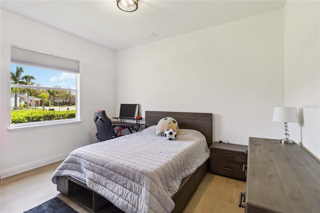 bedroom featuring baseboards and light wood-style floors