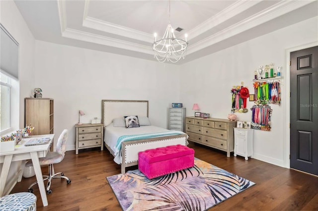 bedroom featuring a chandelier, wood finished floors, a raised ceiling, and crown molding