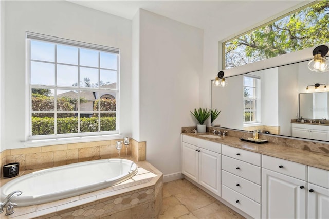 bathroom with a garden tub and vanity