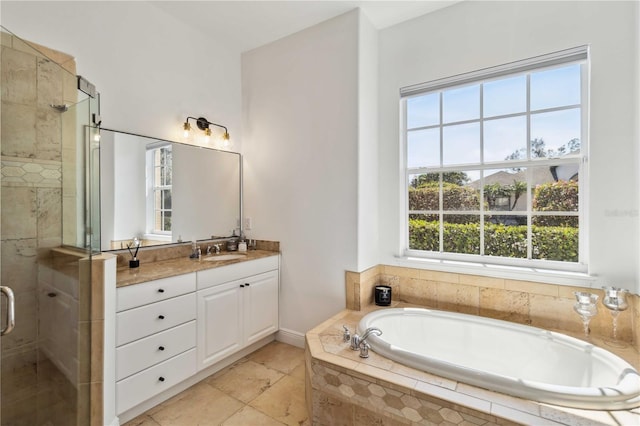 full bathroom with a stall shower, a garden tub, and vanity