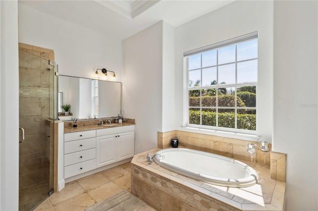 bathroom with a shower stall, a bath, and vanity