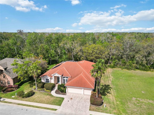 birds eye view of property with a view of trees