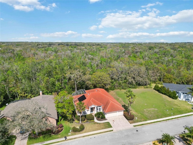 drone / aerial view featuring a forest view