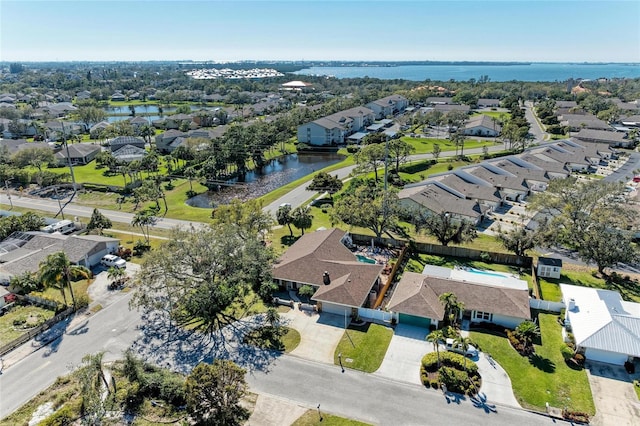 drone / aerial view with a residential view and a water view