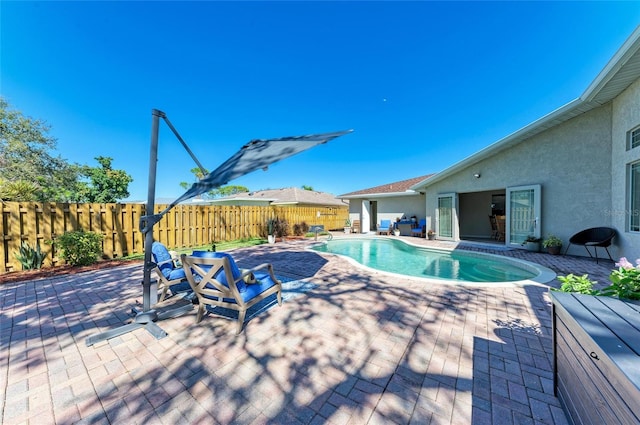 view of pool featuring a fenced in pool, a fenced backyard, and a patio area