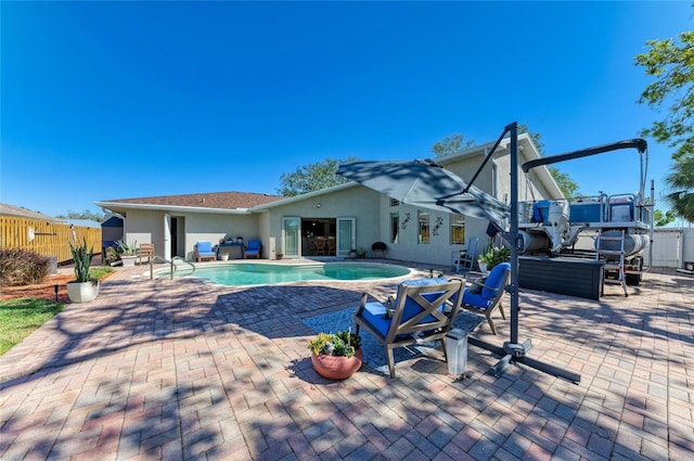 view of pool featuring a fenced in pool, fence, a jacuzzi, and a patio area