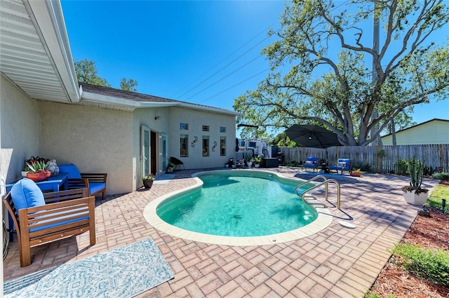 view of pool with a patio, a fenced in pool, a fenced backyard, and an outdoor living space