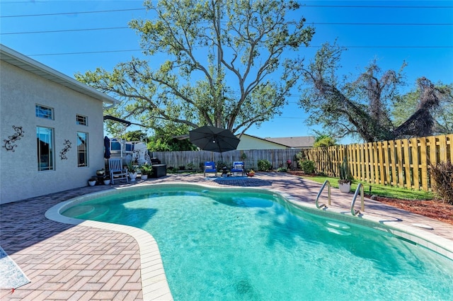 view of swimming pool featuring a fenced in pool, a patio, and a fenced backyard