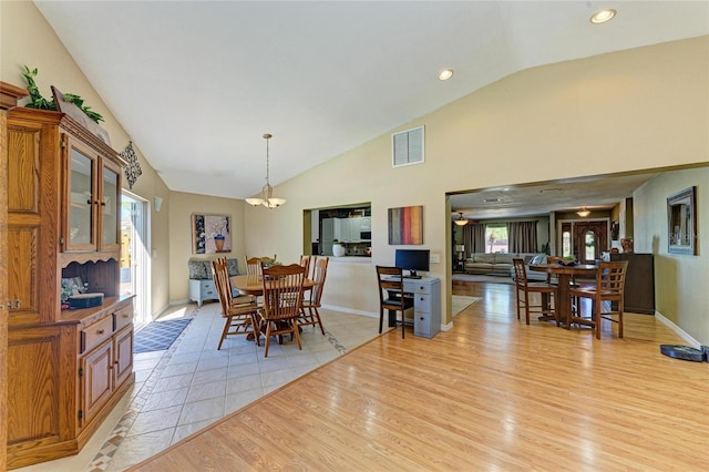 dining space featuring light wood finished floors, visible vents, baseboards, recessed lighting, and high vaulted ceiling