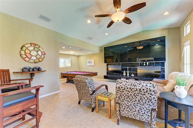 living room featuring baseboards, visible vents, carpet floors, lofted ceiling, and a textured ceiling