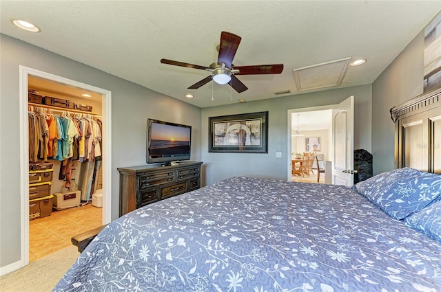 carpeted bedroom with recessed lighting, a textured ceiling, ceiling fan, and a spacious closet