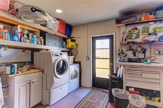 clothes washing area with laundry area, a workshop area, a wealth of natural light, and washer and clothes dryer