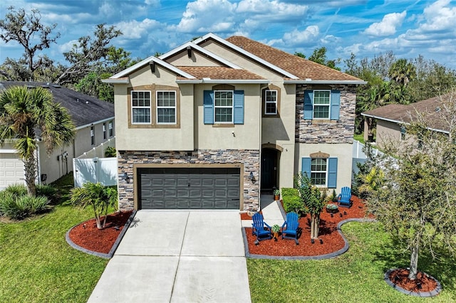 view of front of home with concrete driveway, stone siding, an attached garage, fence, and stucco siding