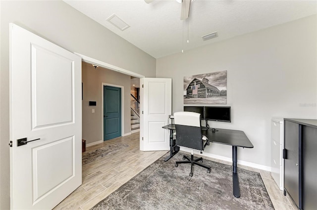 office featuring baseboards, visible vents, a ceiling fan, and wood finish floors