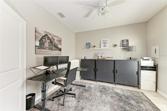 office area featuring a ceiling fan, baseboards, visible vents, and light wood finished floors