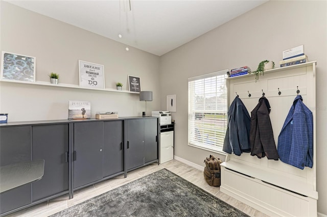 mudroom featuring light wood-type flooring and baseboards