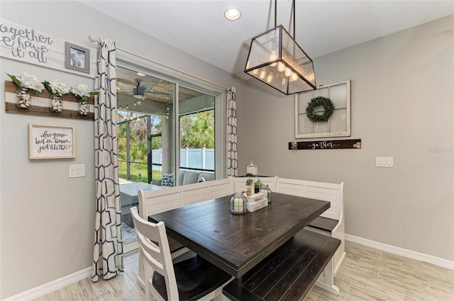 dining area with light wood-type flooring and baseboards