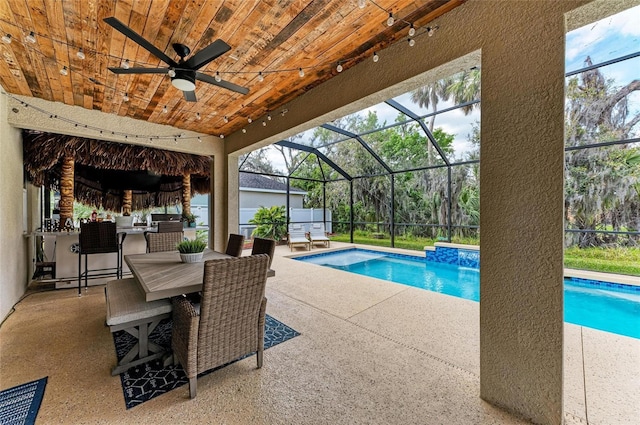 pool featuring ceiling fan, a patio, outdoor dining space, and glass enclosure