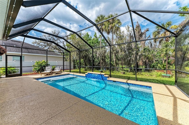 outdoor pool with a lanai, fence, and a patio