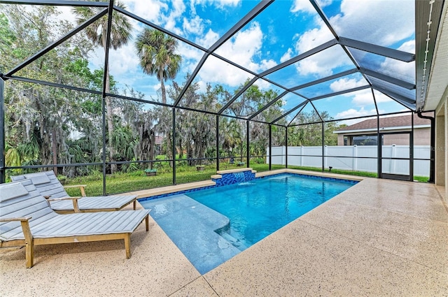 view of pool with a fenced in pool, glass enclosure, and a patio area