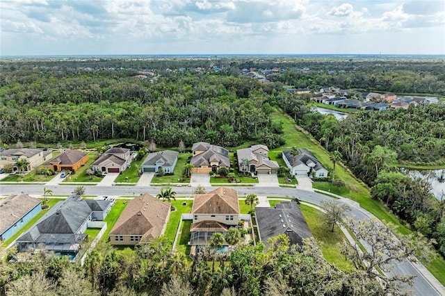 birds eye view of property with a residential view, a water view, and a forest view