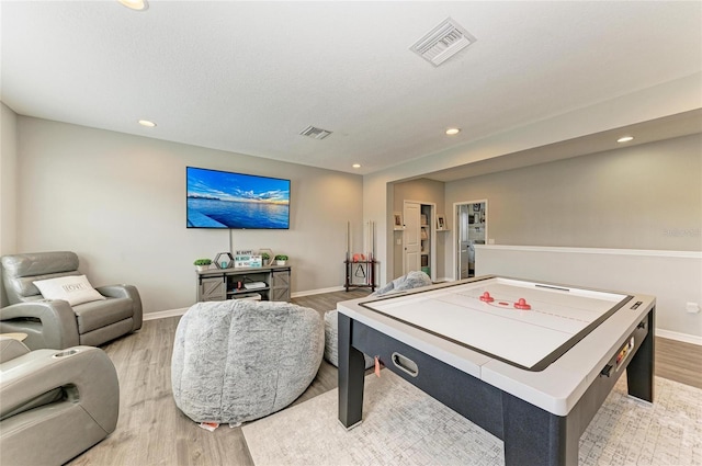 rec room with recessed lighting, visible vents, and light wood-style flooring