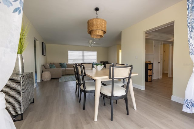 dining room with light wood-type flooring and baseboards