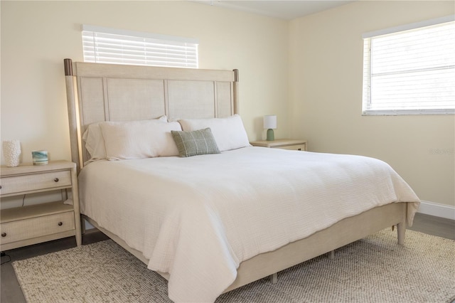 bedroom featuring wood finished floors and baseboards