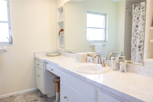 full bath featuring curtained shower, baseboards, and vanity