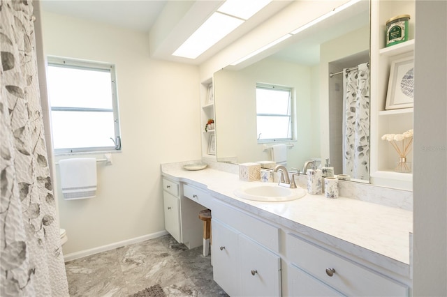 full bathroom featuring a shower with shower curtain, vanity, and baseboards