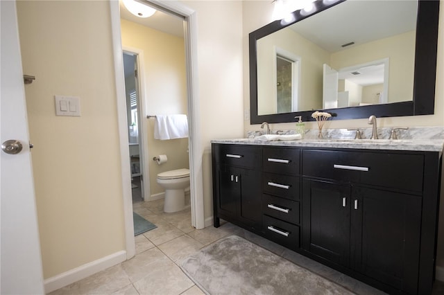 full bathroom with double vanity, visible vents, baseboards, toilet, and a sink