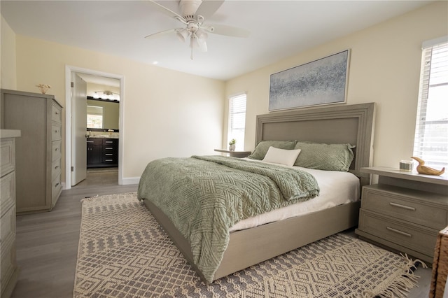 bedroom featuring light wood finished floors, multiple windows, baseboards, and a ceiling fan