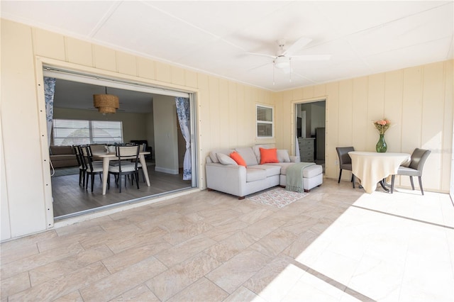 living area featuring a ceiling fan