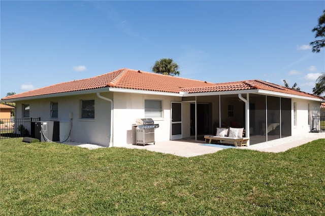 back of house with a lawn and a tile roof