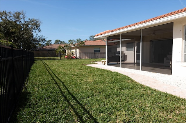 view of yard with a ceiling fan, a fenced backyard, and a patio