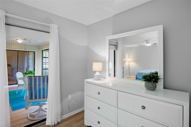 bedroom featuring baseboards and wood finished floors